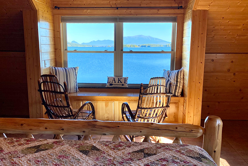 Two rocking chairs face the window with a view of Katahdin
